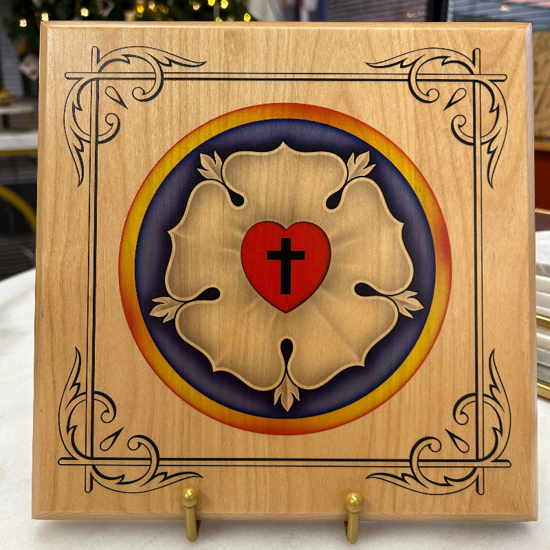 9" Wooden plaque with decorative emblem featuring a red circle with a black cross on a blue background, surrounded by gold leaf designs.
